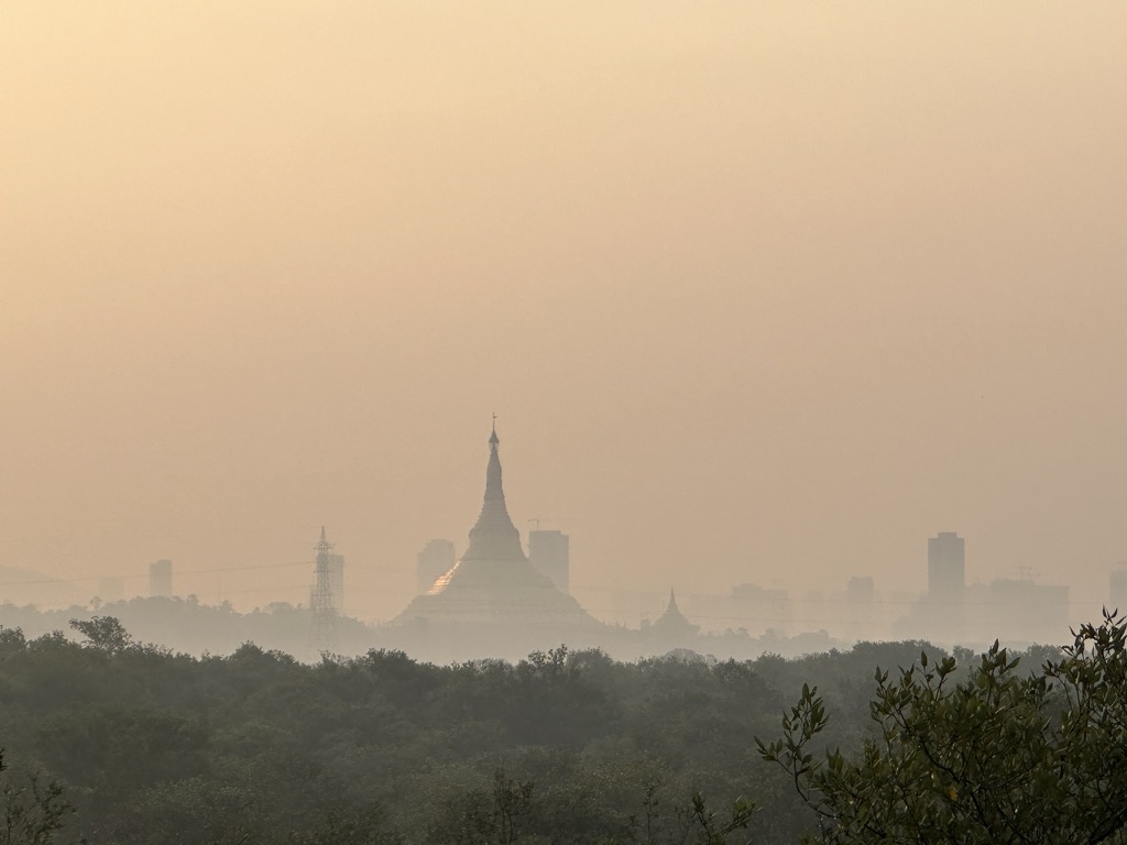 The pagoda through the morning haze, above the mangroves