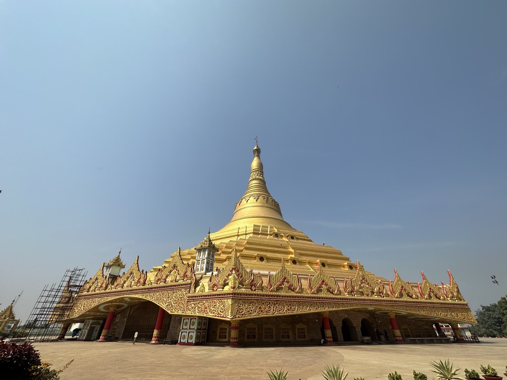 The Global Vipassana Pagoda rising gold against a clear sky