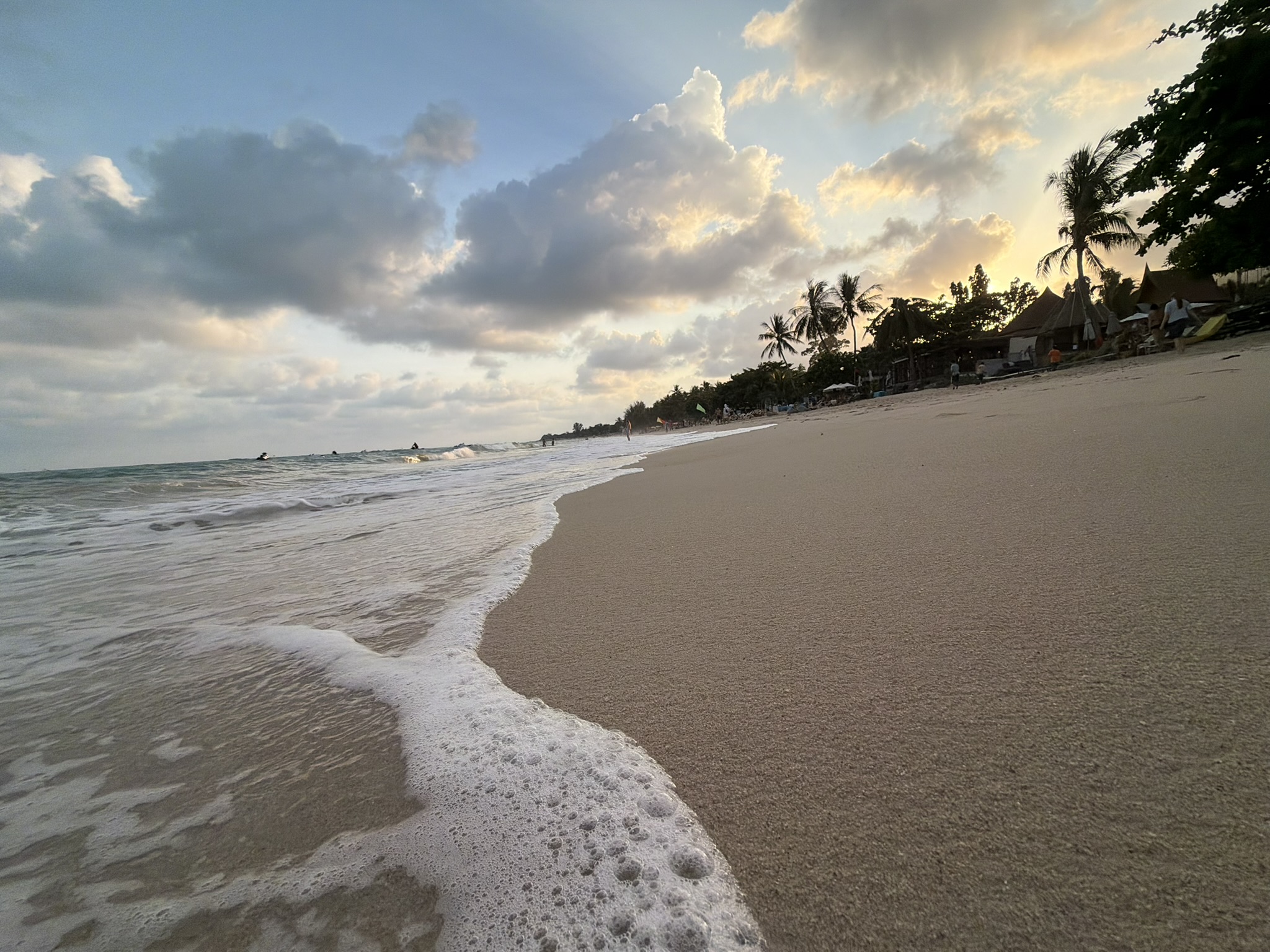 Waves on the sand at sunset