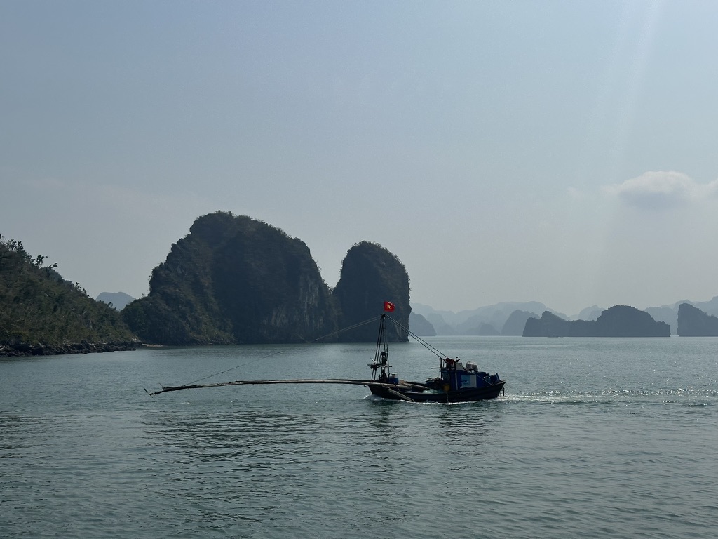 Fishing boat among the karsts of Ha Long Bay